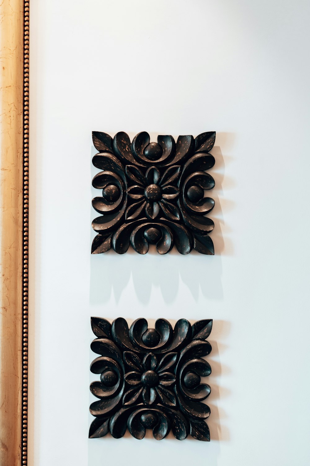 a pair of decorative wooden wall hangings on a wall