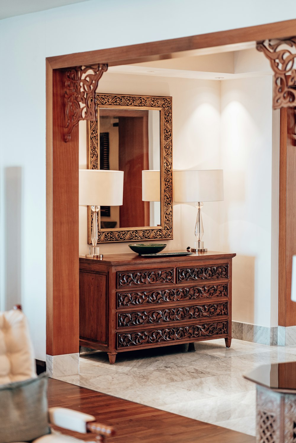 a wooden dresser with a mirror on top of it