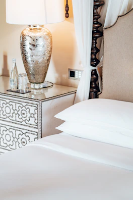 Elegant bedside table with a stylish lamp and decorative items.