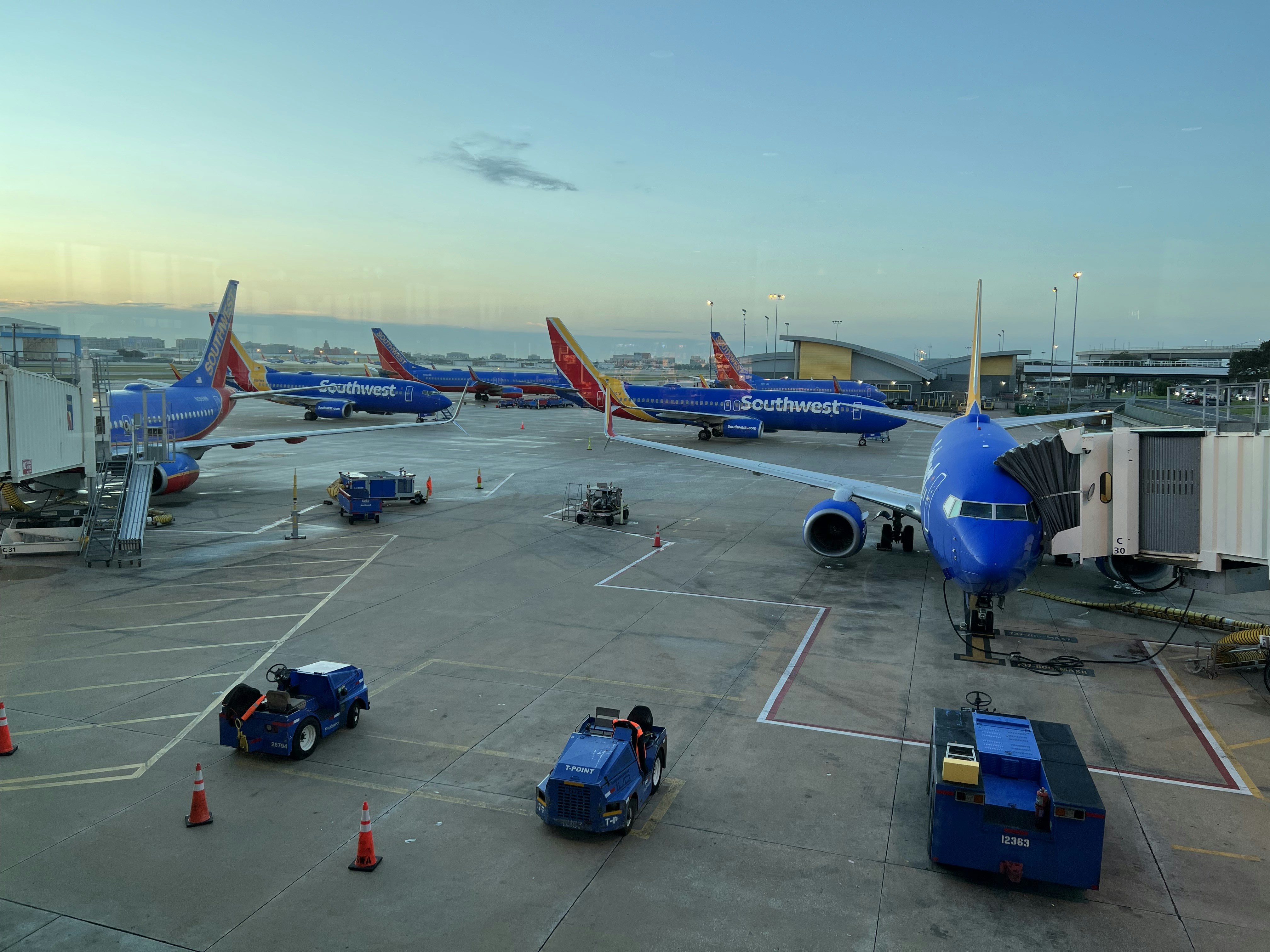 a group of airplanes parked on top of an airport tarmac