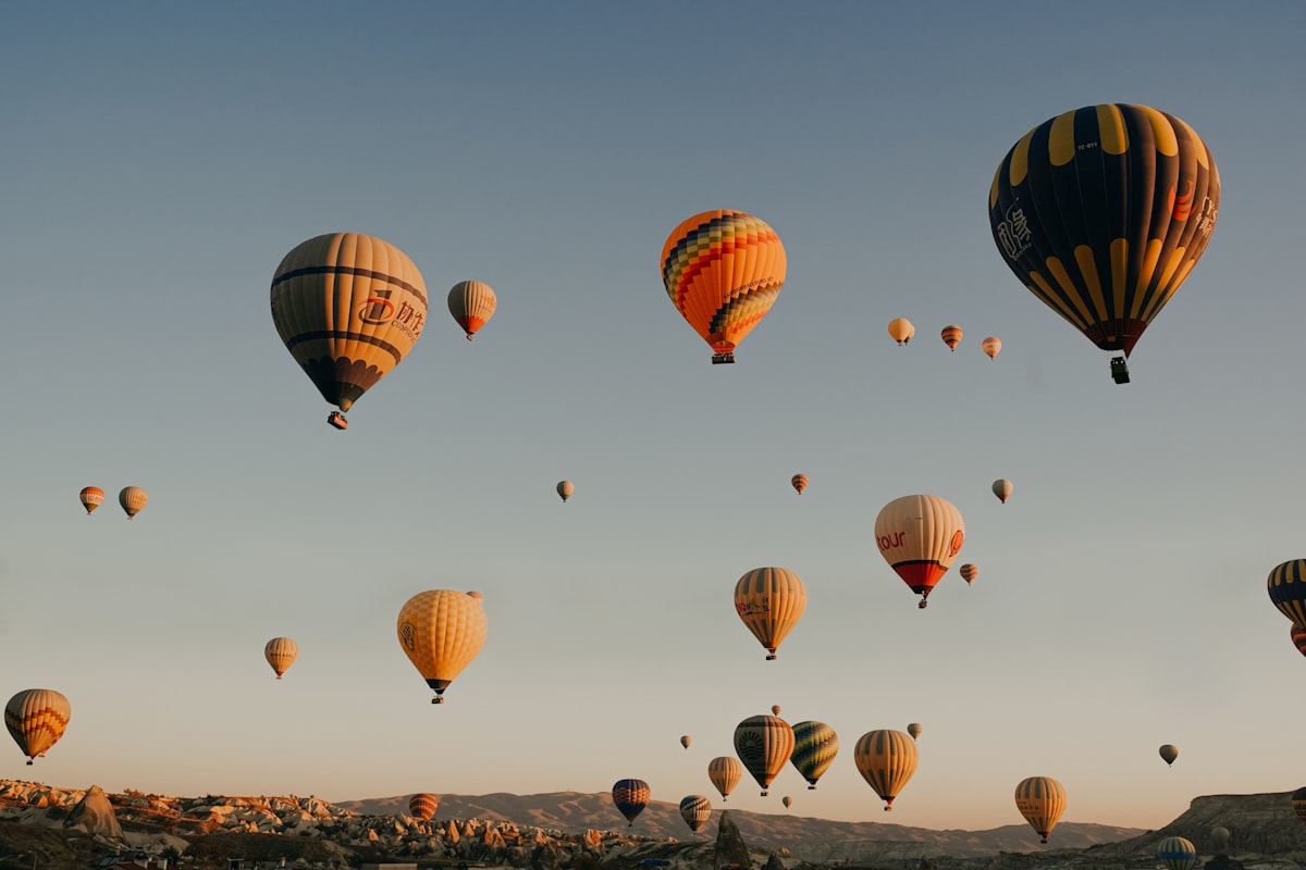 Cappadocia November — the quiet volcanic valleys with golden autumn foliage against the bare rocky fairy chimneys
