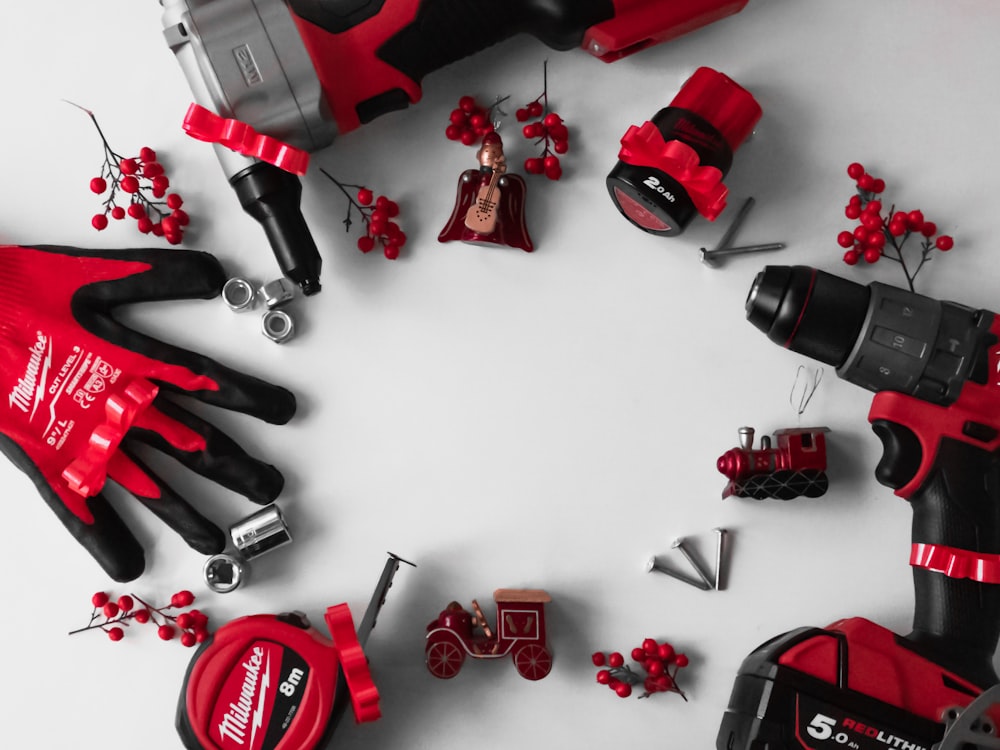 a group of red and black tools on a white surface