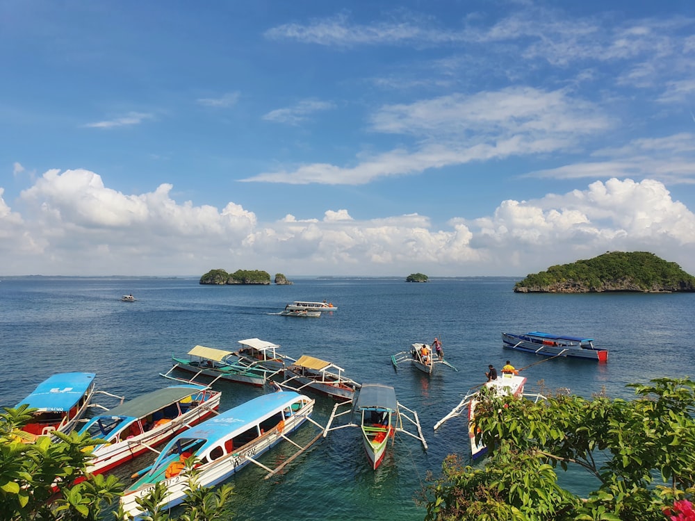 a group of boats floating on top of a body of water