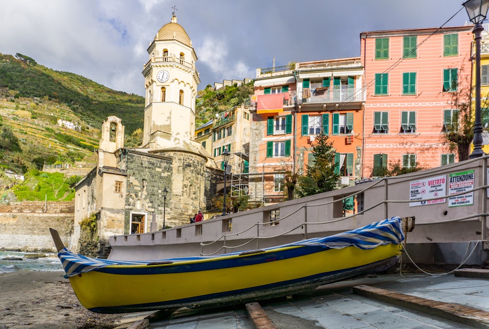 a yellow boat sitting on top of a wooden dock