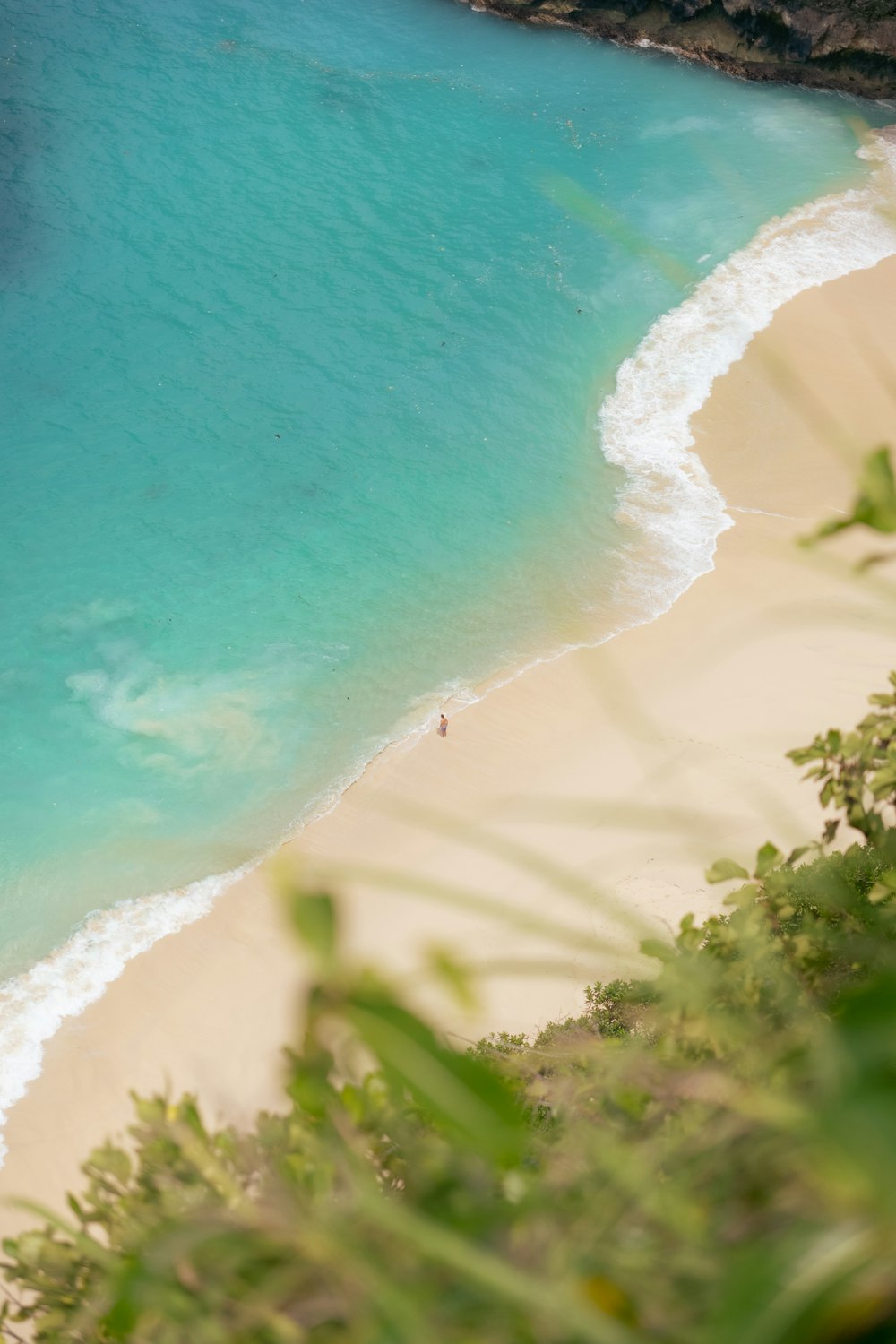 a view of a beach with a person in the water