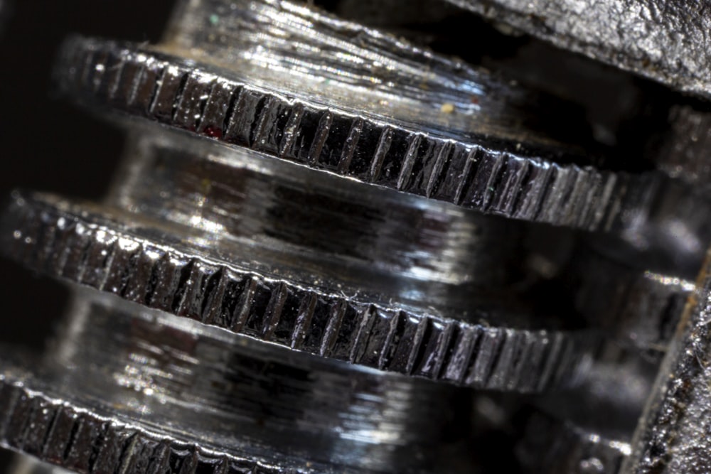 a close up of a metal object with a black background