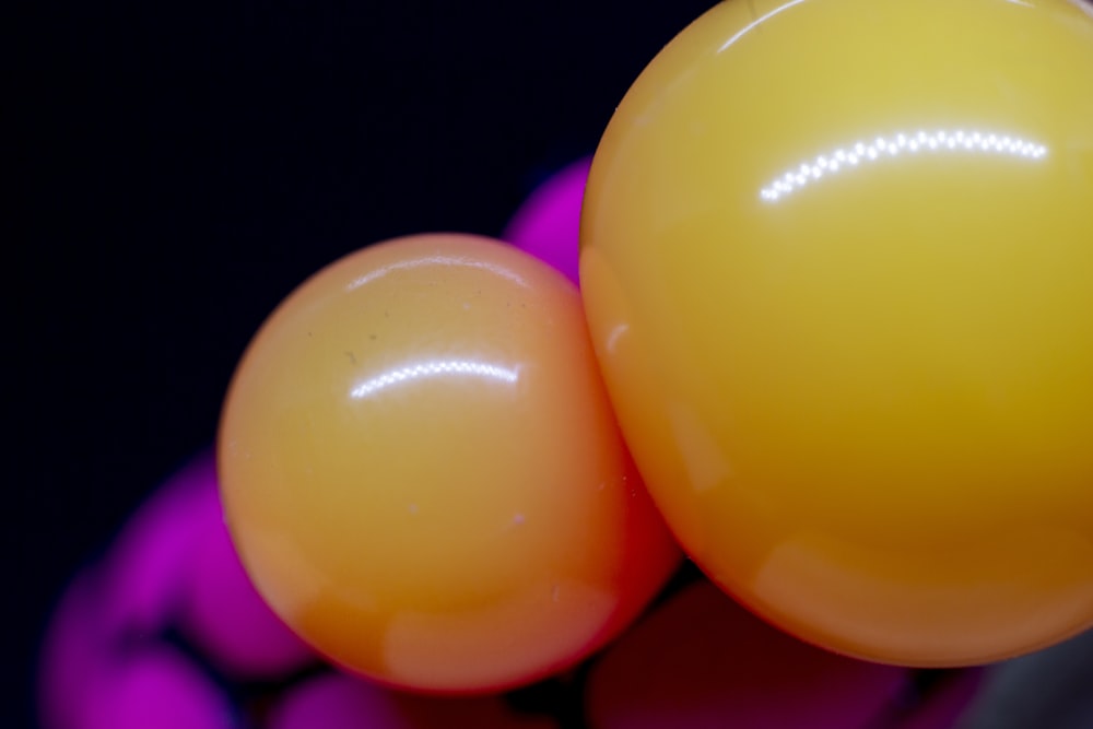 a close up of two balloons on a black background