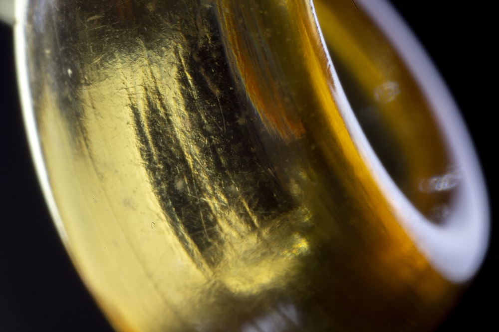 a close up of a yellow vase with a black background