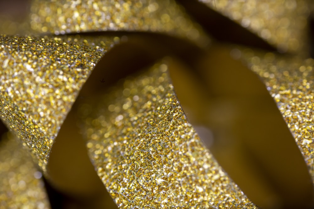 a close up of a gold glitter ribbon