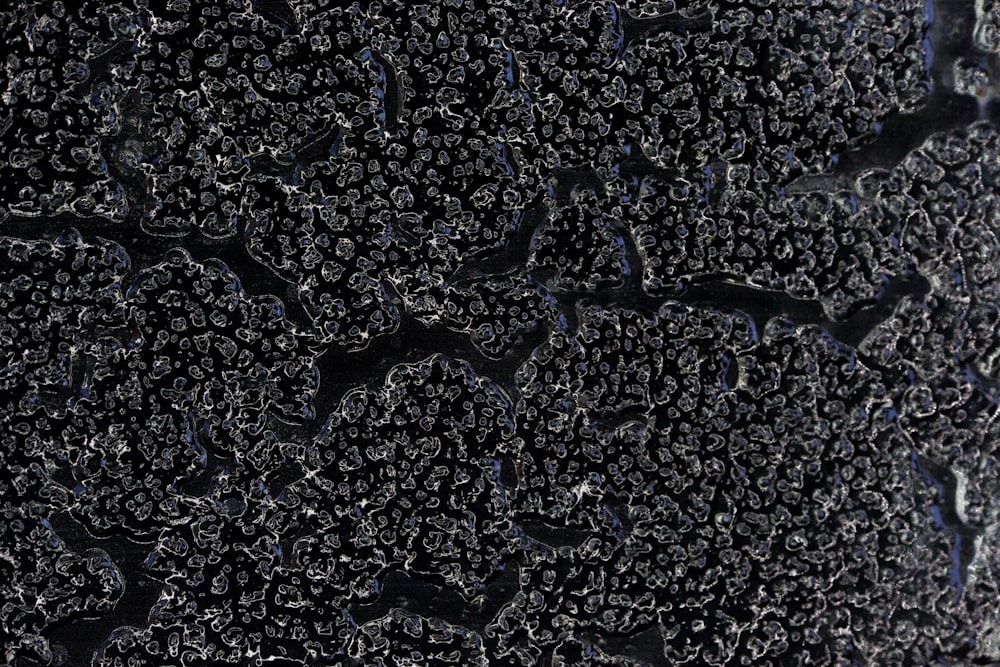 a close up of the surface of a black surface