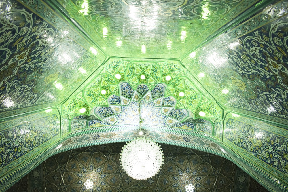 the ceiling of a building with a chandelier hanging from it