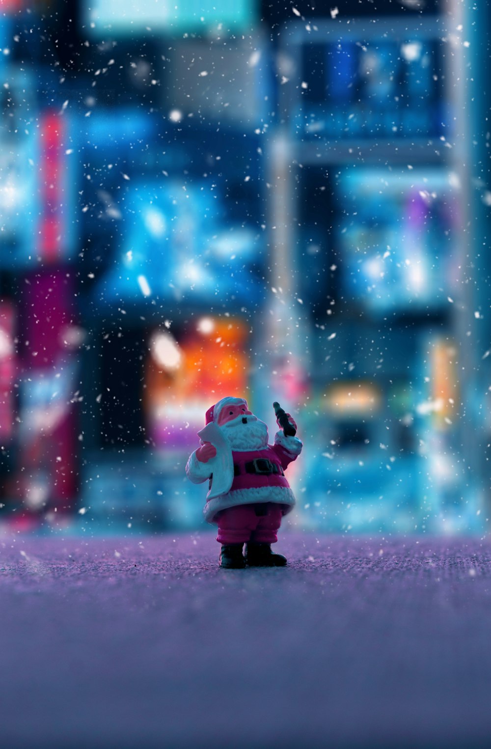 a toy santa clause is standing in the snow