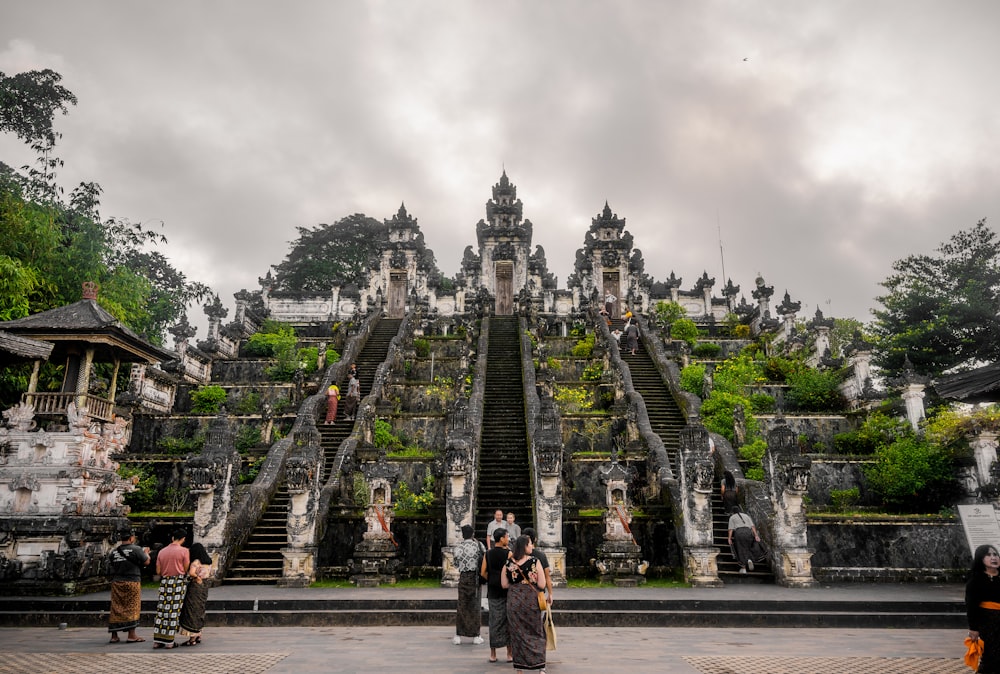 a group of people standing in front of a large building