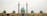 A large mosque with a central blue dome and multiple smaller domes on each side. Two tall minarets flank the central structure, adorned with intricate patterns. The architecture features a combination of yellow and turquoise tiles, showcasing detailed craftsmanship.