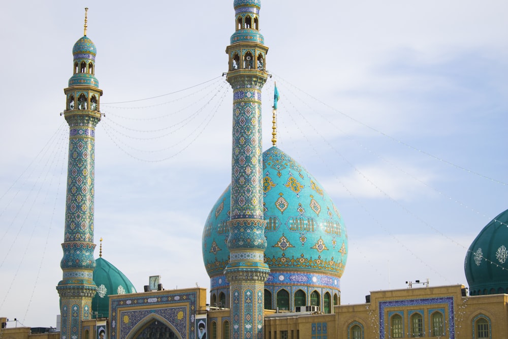 a large blue and gold building with two towers