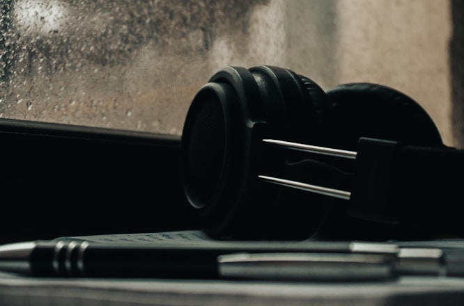 a pen and headphones sitting on a window sill