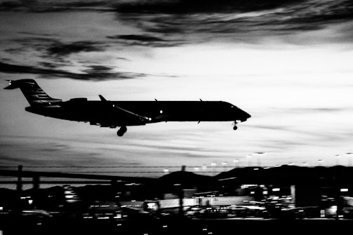A dramatic shot of a plane taking off with the Munich skyline faintly visible in the background.