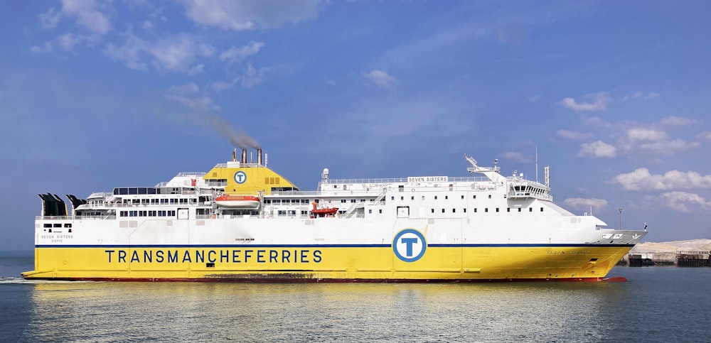 a large white and yellow boat in the water