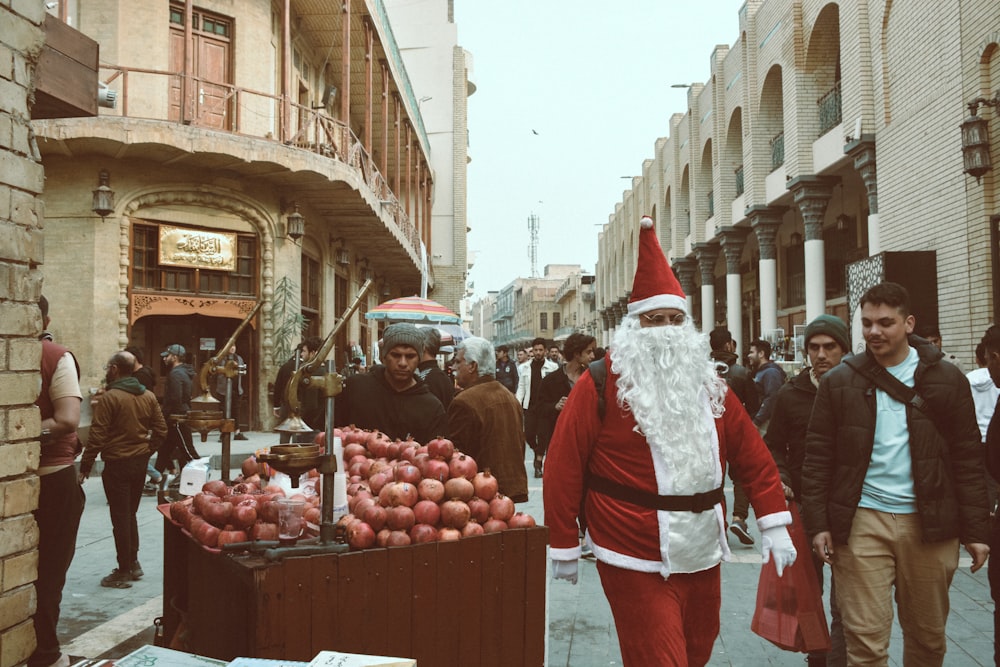 a man dressed as santa claus walking down a street