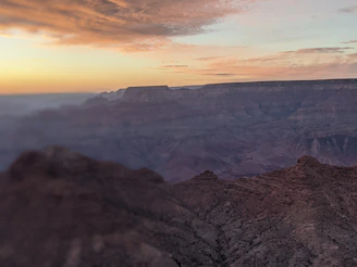 A vibrant sunset over the cliffs of Barrancas del Cobre with travelers enjoying the view.