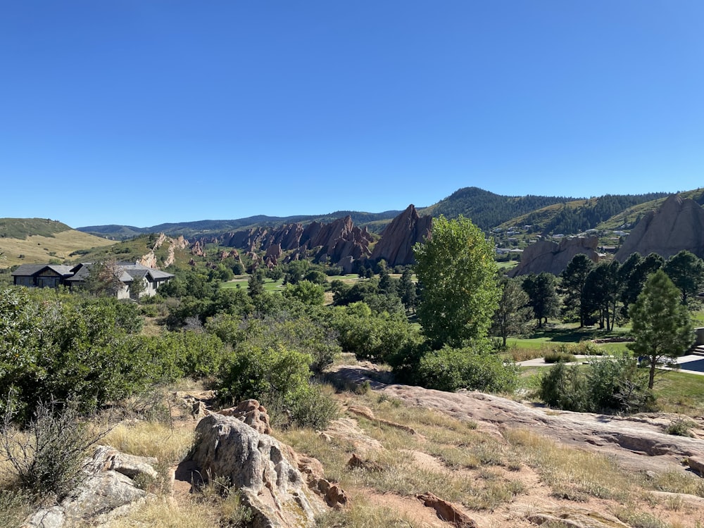 a scenic view of a mountain range with houses in the distance