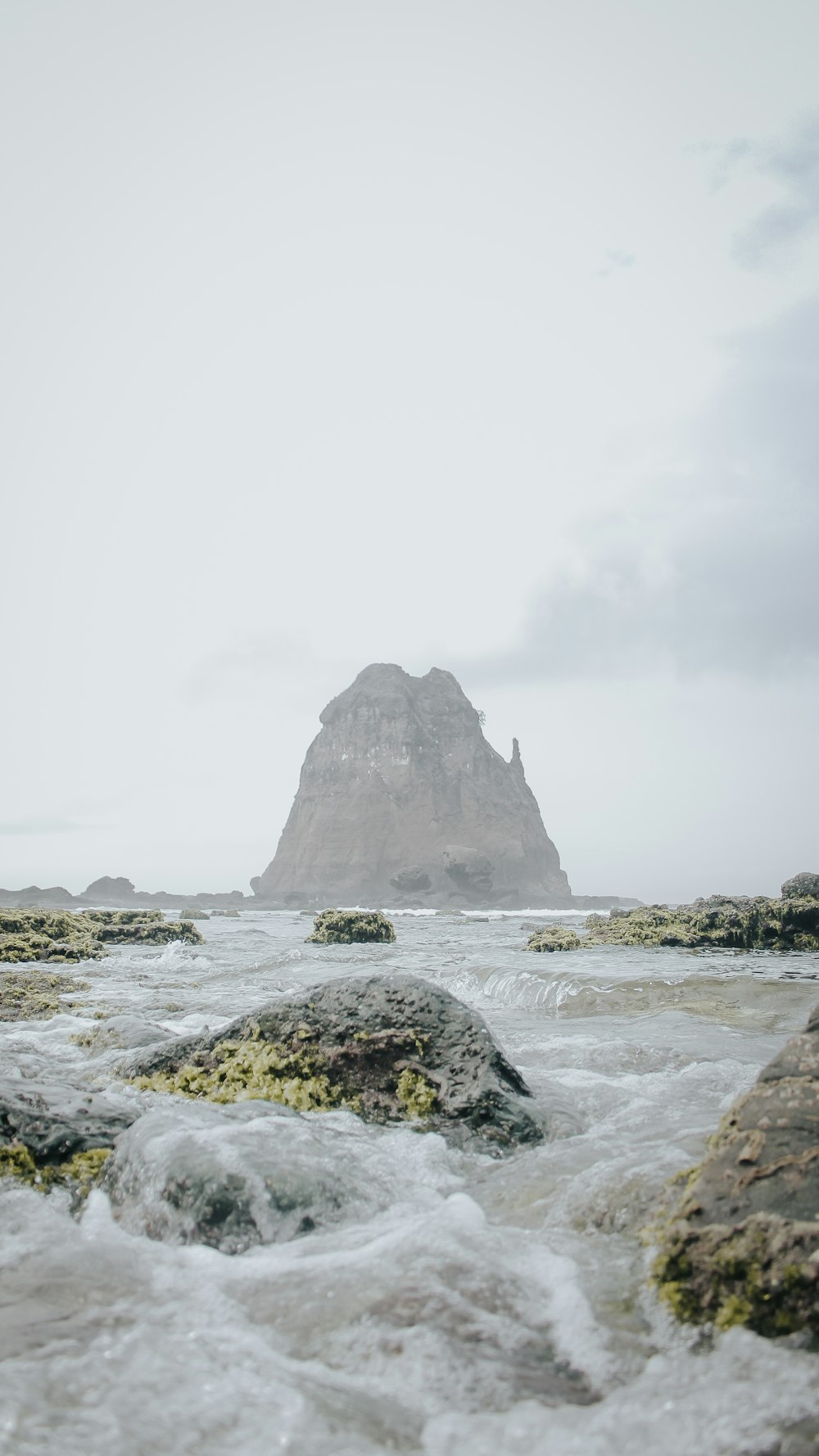 a rock in the middle of a body of water