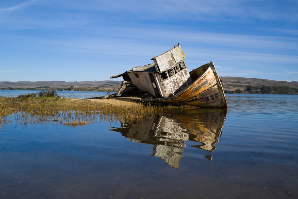 an old boat sitting on top of a body of water