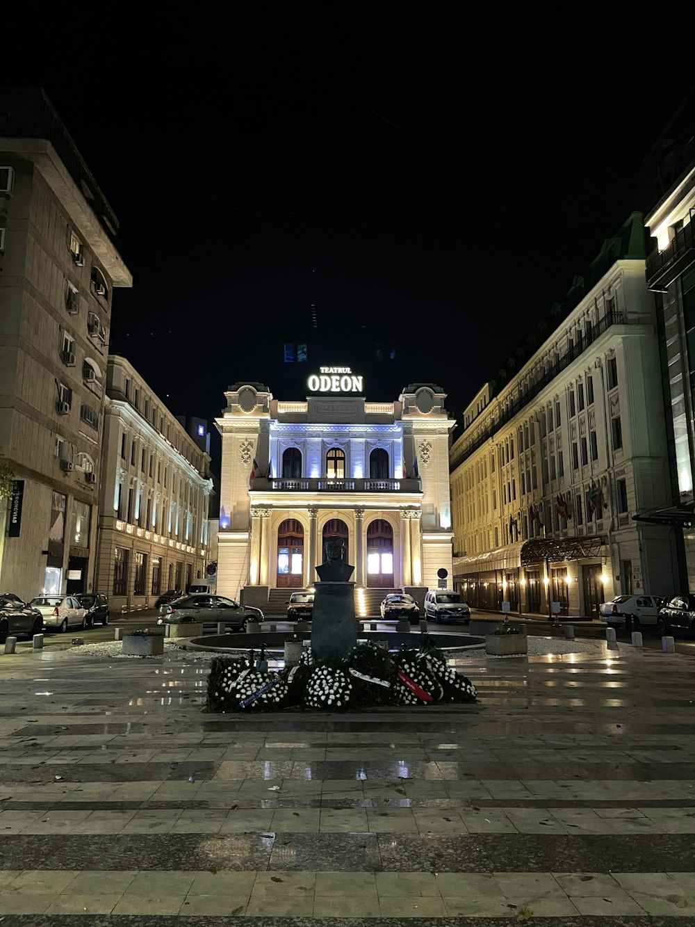 a large building with a fountain in front of it