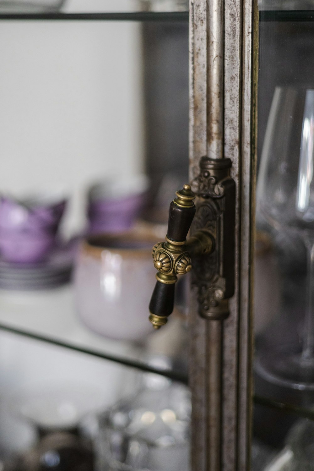 a close up of a door handle on a glass shelf