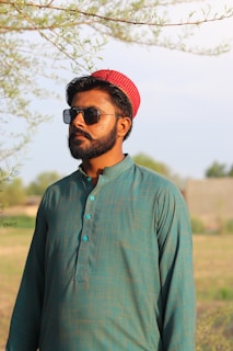 A customer wearing a soft beige kapor kurta, smiling in a sunlit garden.
