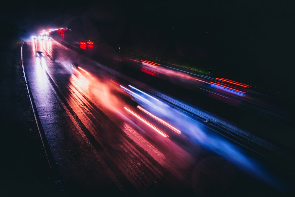 a city street filled with traffic at night