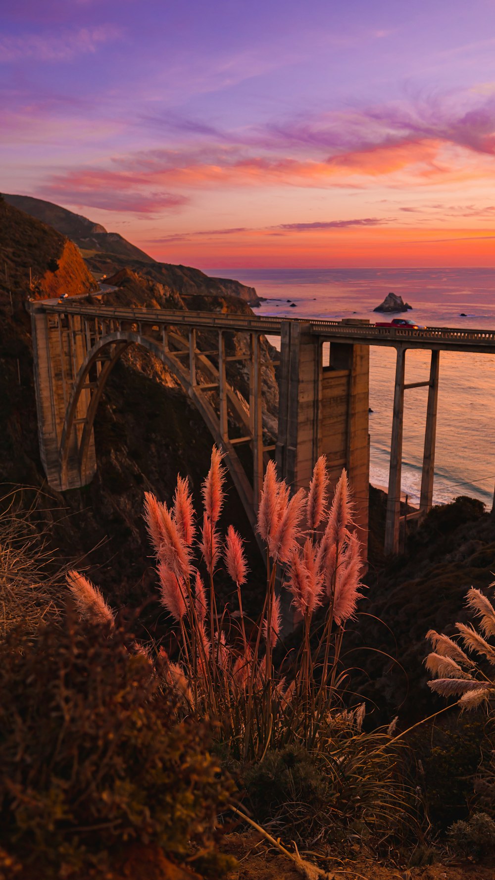 a bridge over a body of water at sunset