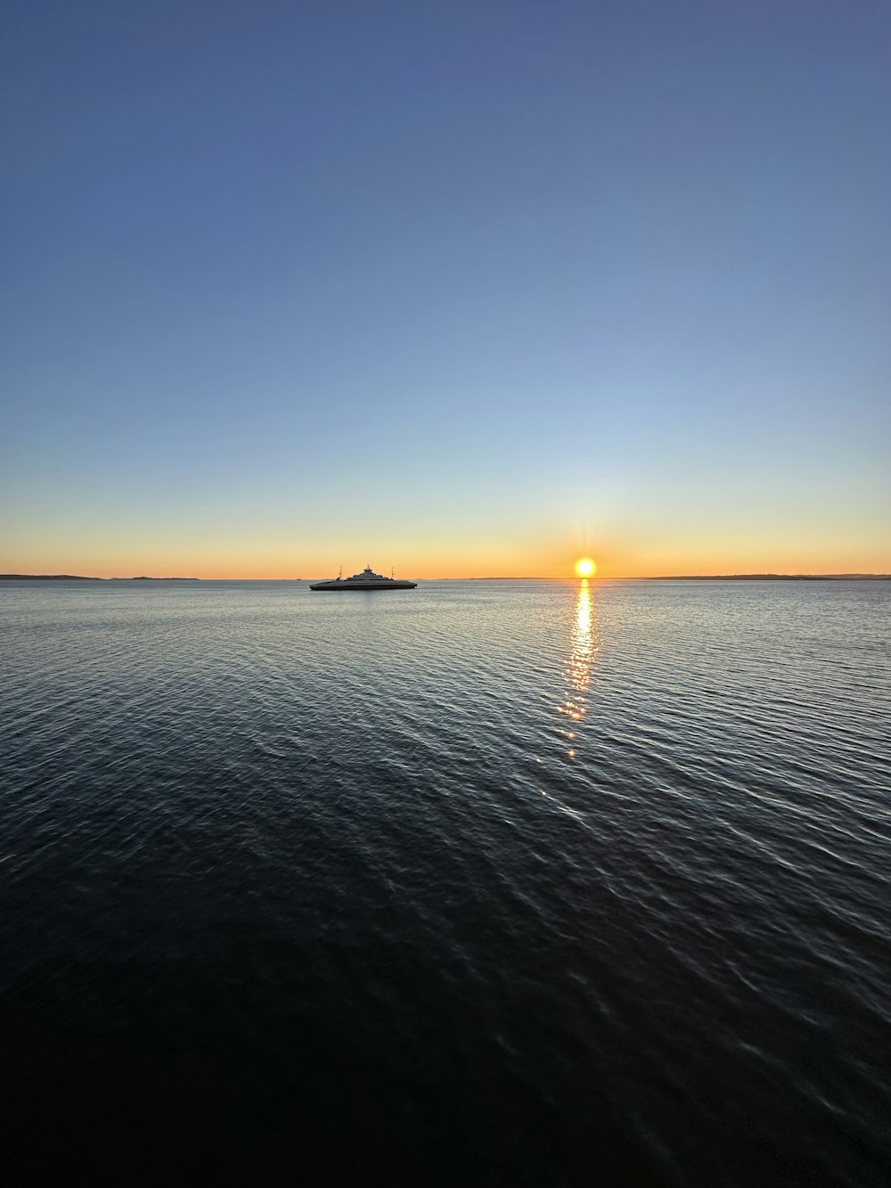 El sol se está poniendo sobre una gran masa de agua