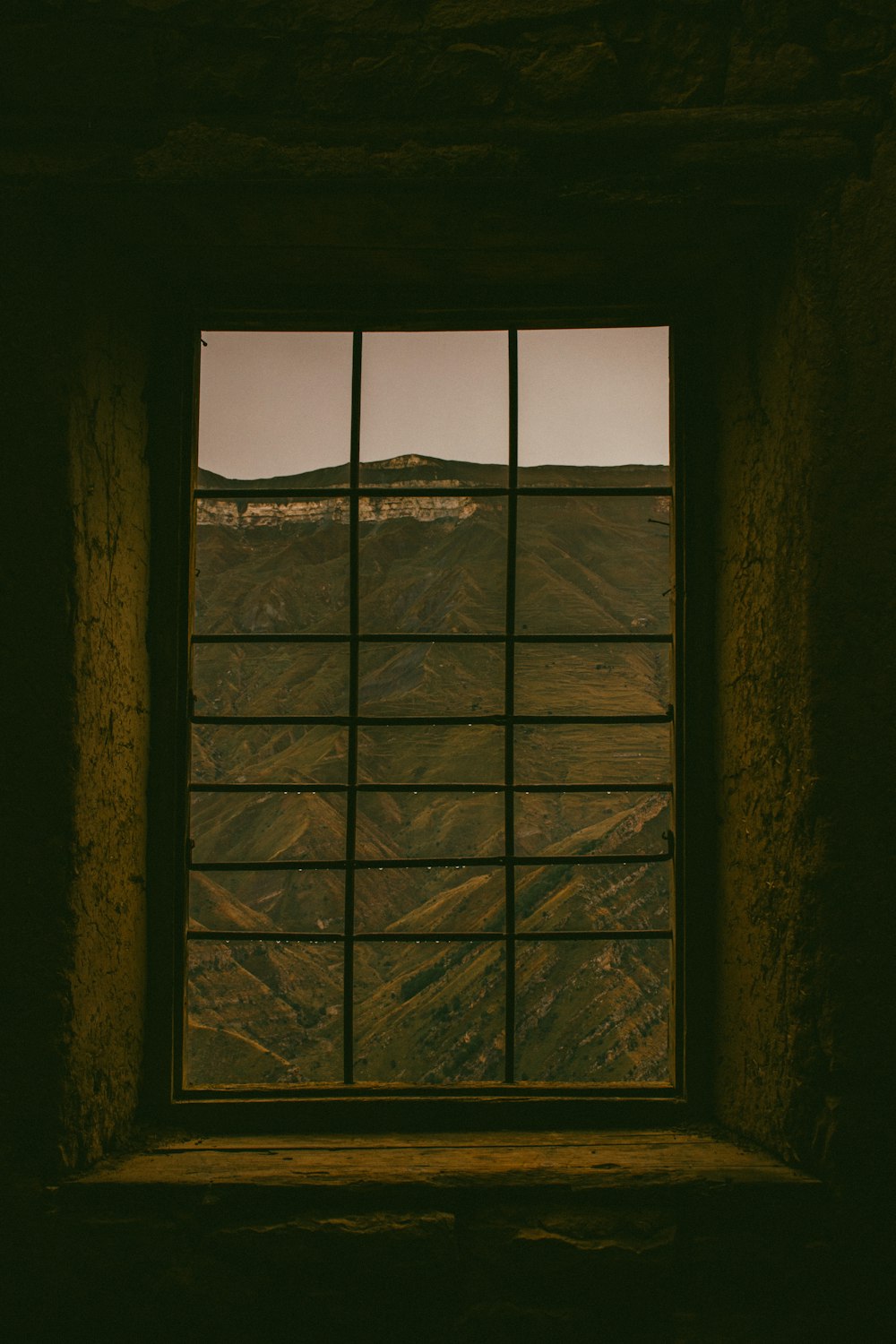 a window with a view of a mountain