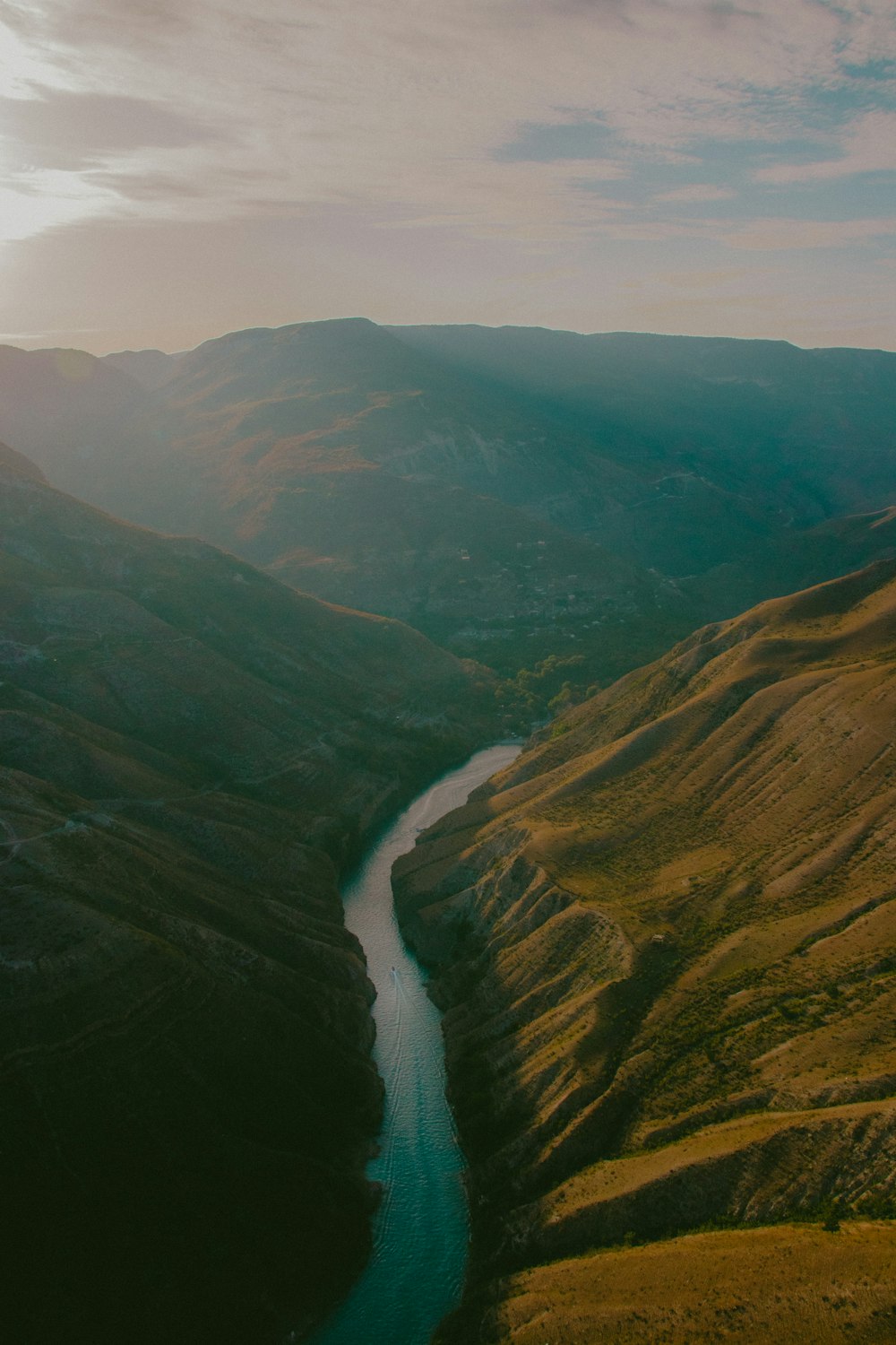 a river running through a lush green valley