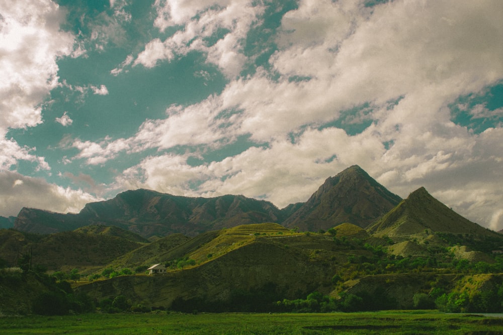 a scenic view of a mountain range under a cloudy sky