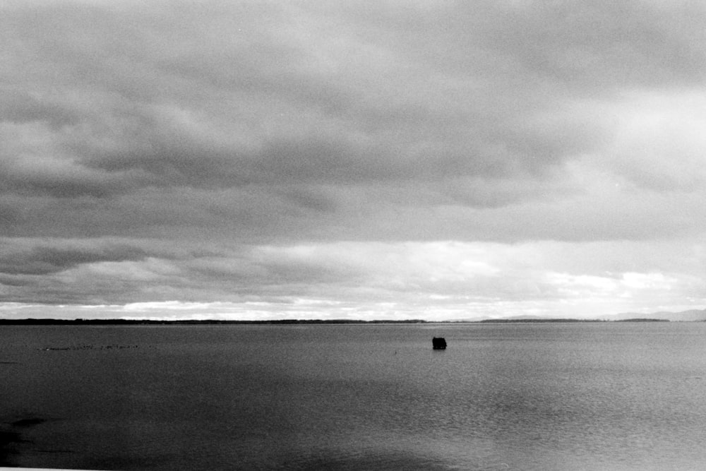 a large body of water under a cloudy sky