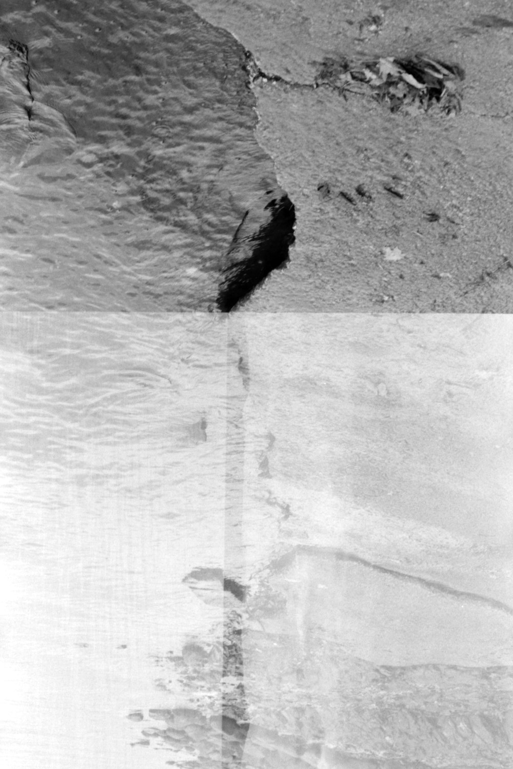 a black and white photo of water and rocks