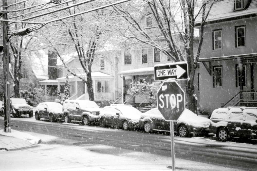 a black and white photo of a snow covered street