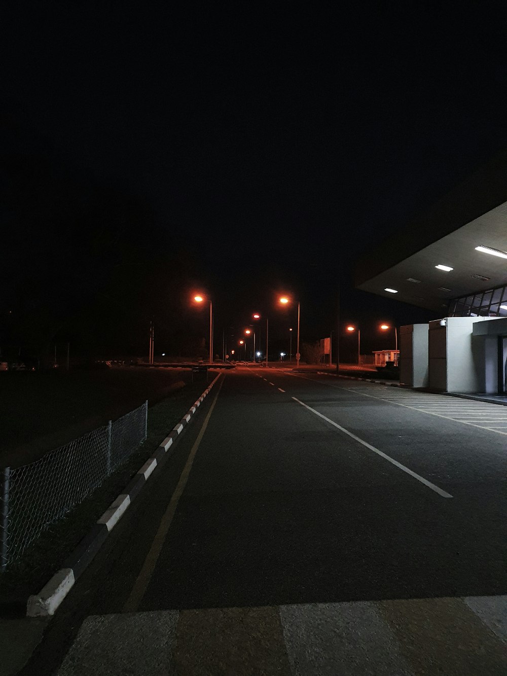 an empty parking lot at night with lights on