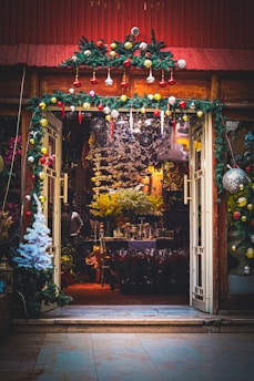 a store front with christmas decorations on the outside of it