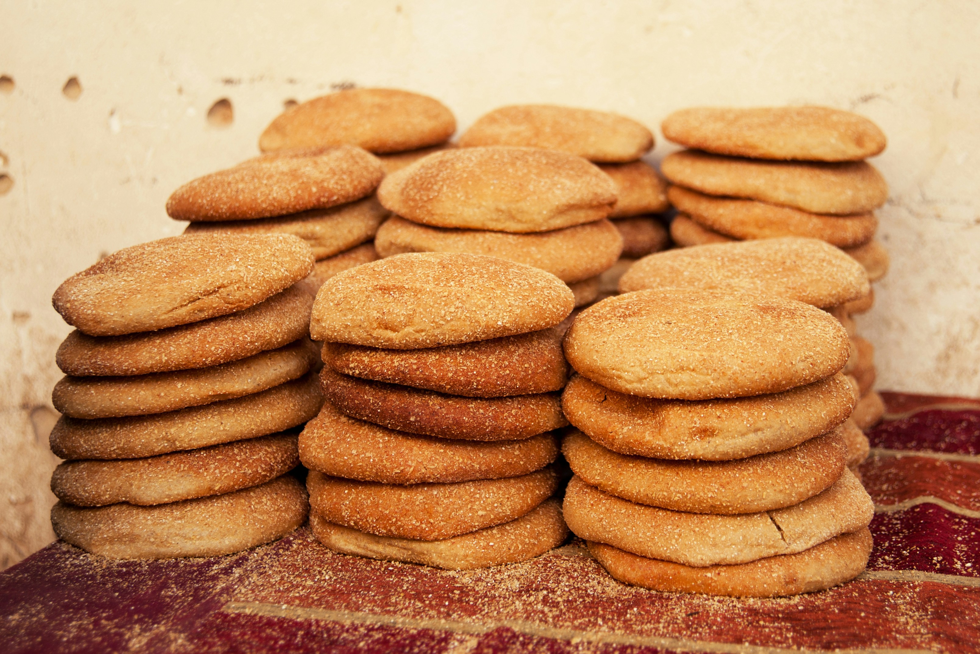 a stack of cookies sitting on top of a red rug