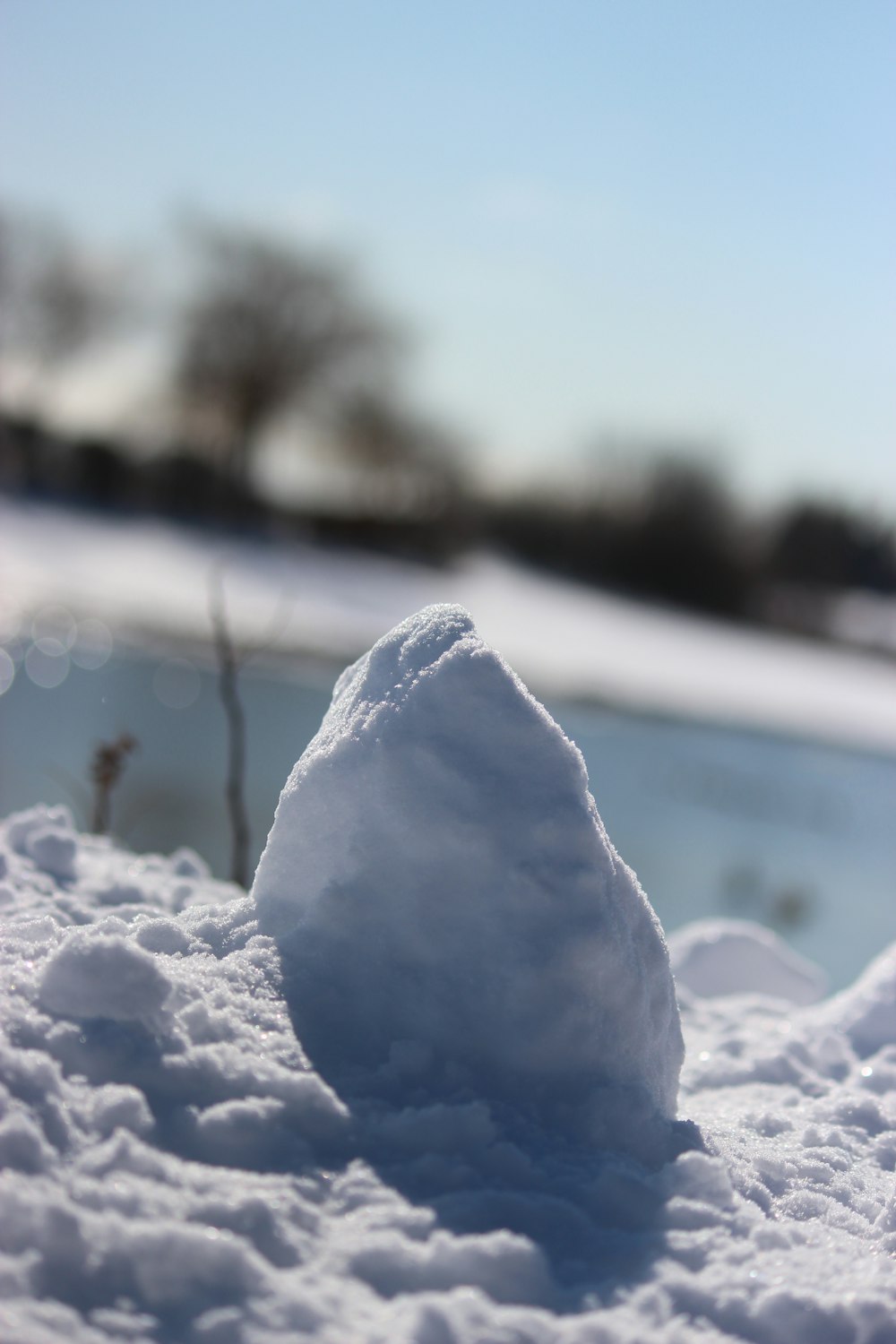 a pile of snow sitting on top of a snow covered ground