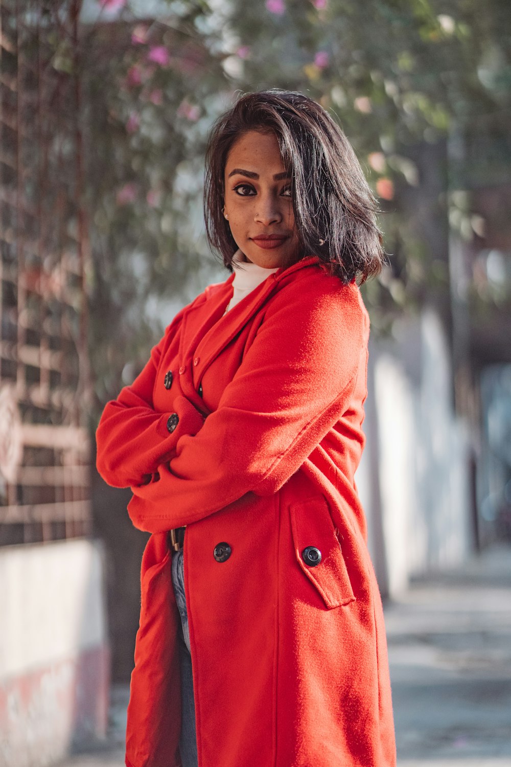 a woman in a red coat posing for a picture