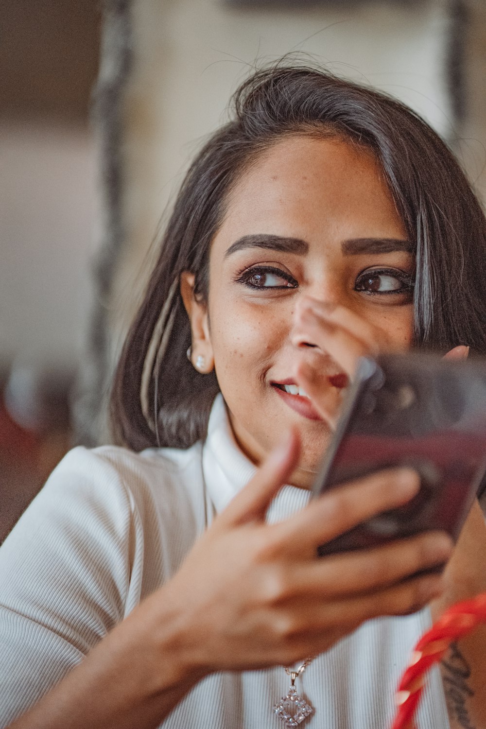 a woman holding a cell phone in her hand