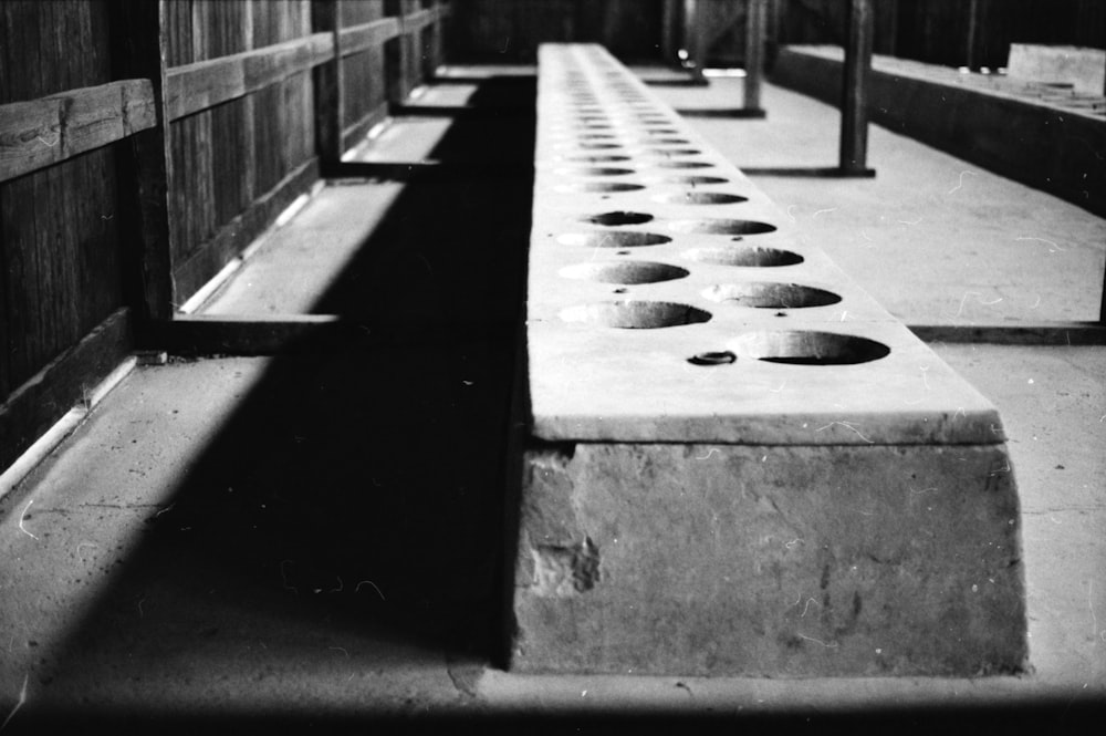 a black and white photo of a row of benches