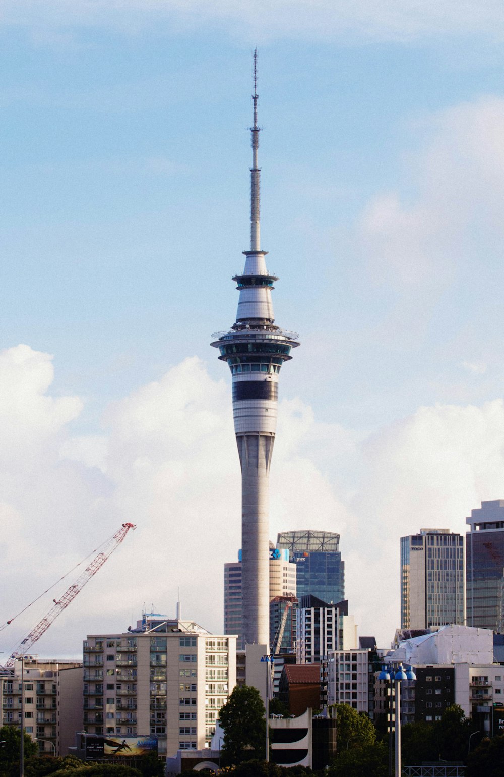 a view of a tall building with a crane in the background