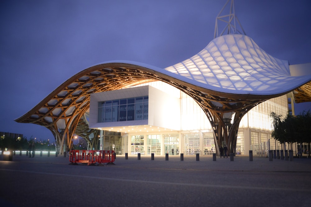 a large white building with a wooden roof