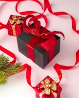 A selection of men's and women's gift boxes displayed with playful red and black accents.
