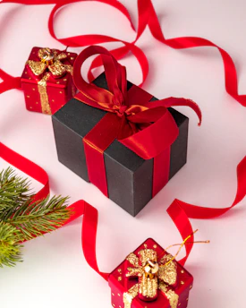 A vibrant display of assorted festive gift boxes wrapped in elegant paper with ribbons.
